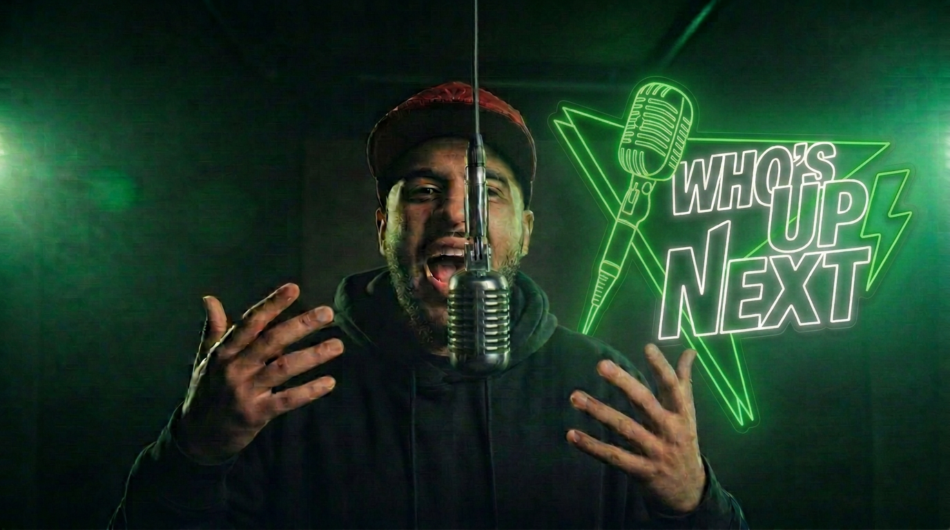 Rapper performing under a red spotlight in the Who's Up Next booth